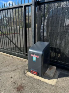 A LiftMaster slide gate operator on a concrete base, demonstrating modern automatic gate trends for secure properties.